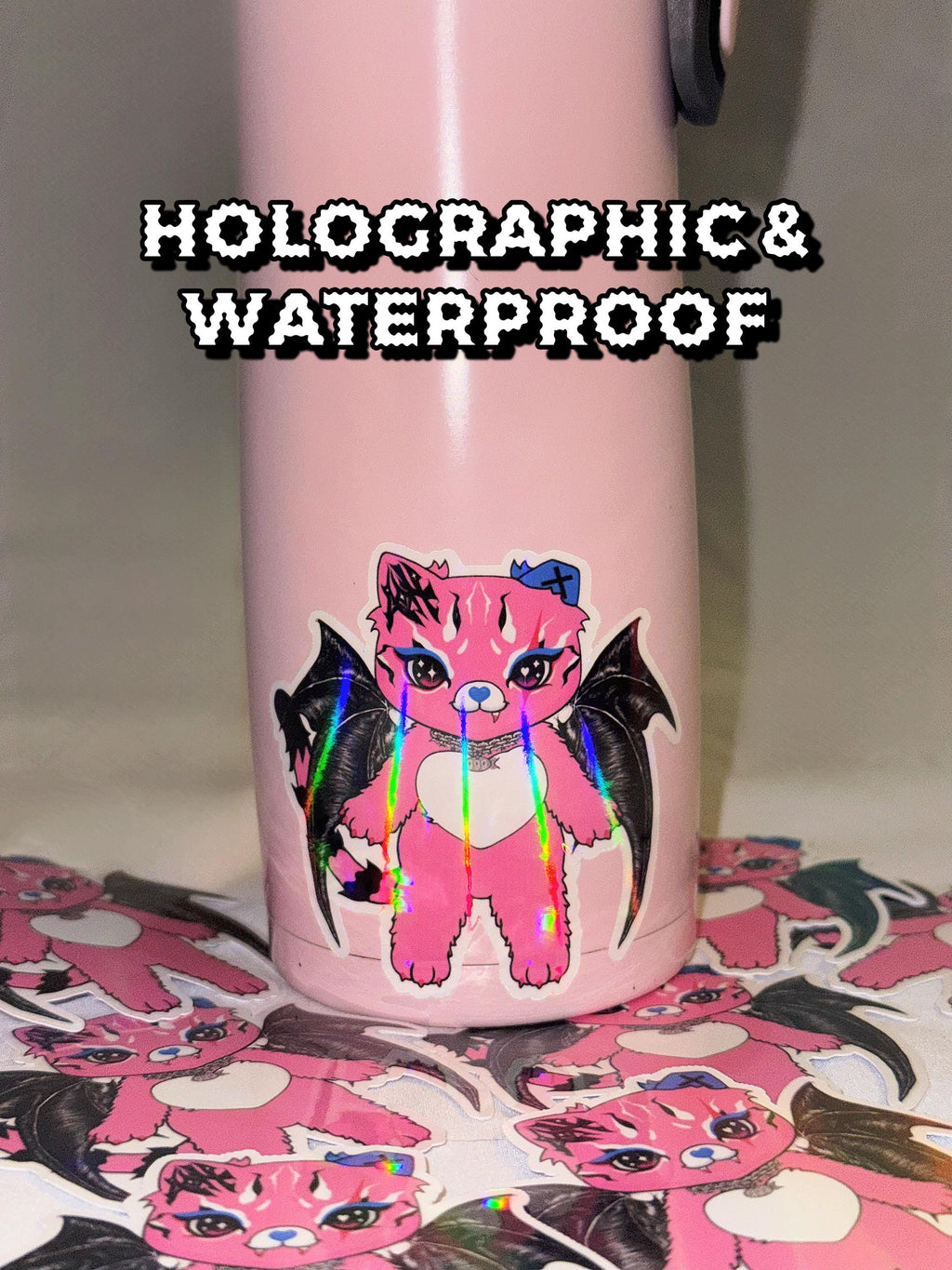 Holographic Tommi the Batcat sticker applied to pink tumbler; waterproof vinyl decal